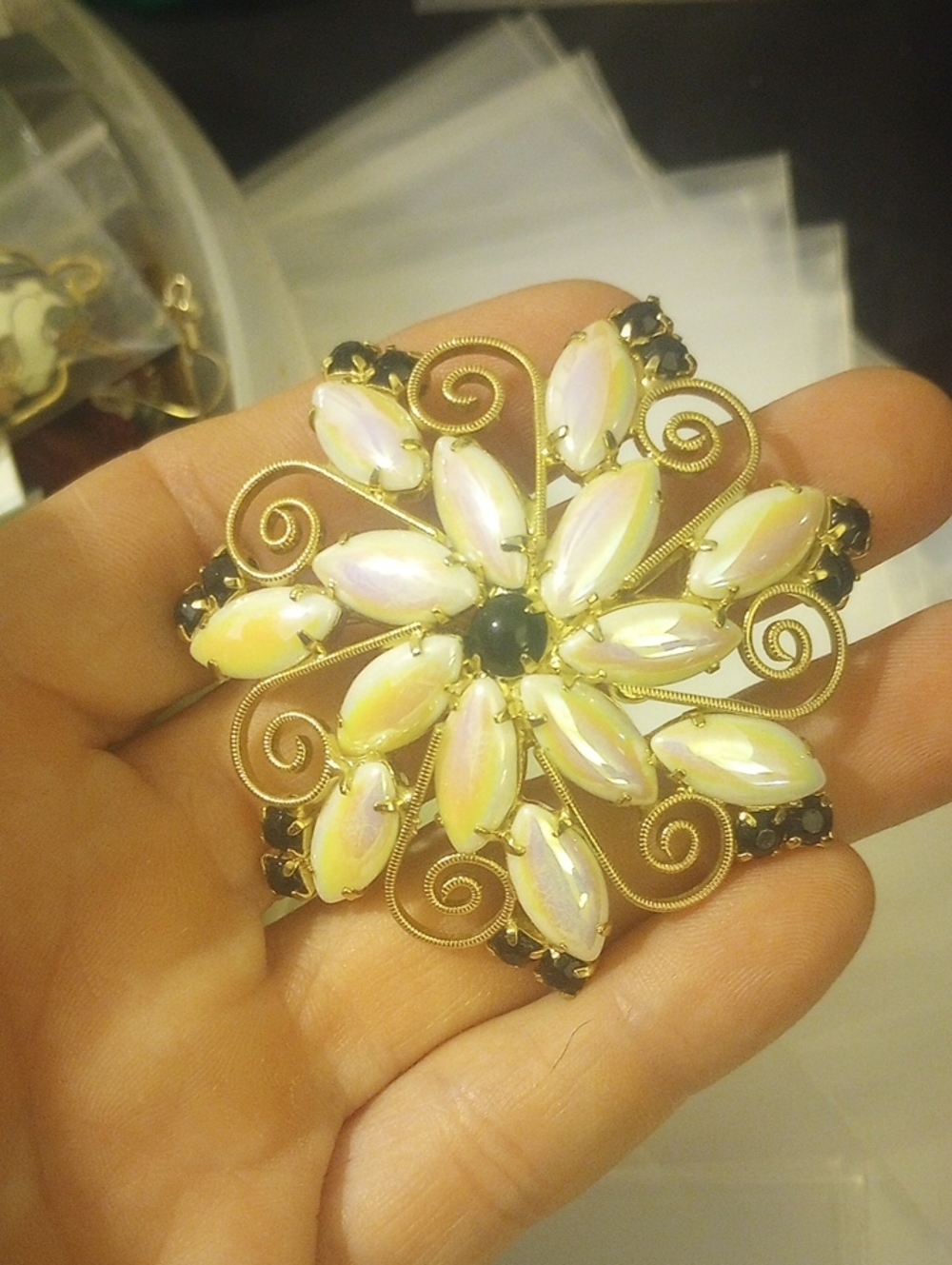 Gold-Tone Floral Brooch with Opalescent White Stones and Black Accents